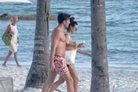 Mark Wright and Michelle Keegan look loved-up on the beach together as they soak up the sun in..