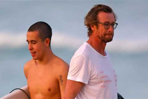 Simon Baker goes into the sea with his son Harry on the beach