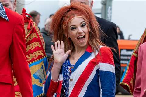 Ginger Spice lookalike waves at camera in Union Jack dress in scenes for The Crown