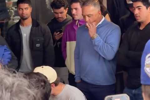 Dave Roberts puffs on cigar while watching wing-eating contest