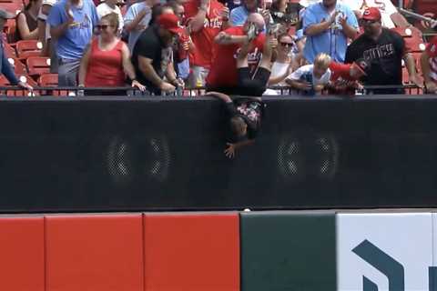 Reds fan has strange defense for dangling child over wall